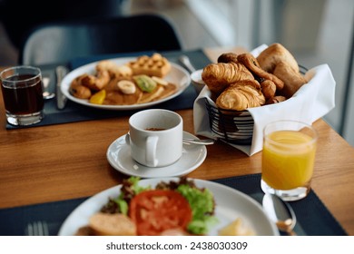 Close up of cup of coffee and buffet breakfast in hotel restaurant. - Powered by Shutterstock