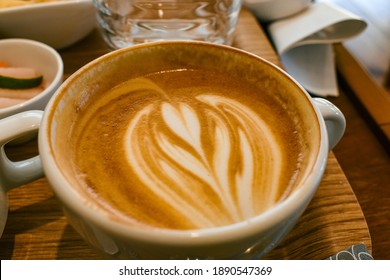 Close Up Of A Cup Coffee Cappuccino With Cream Flower Pattern Of Hot Latte Art. 