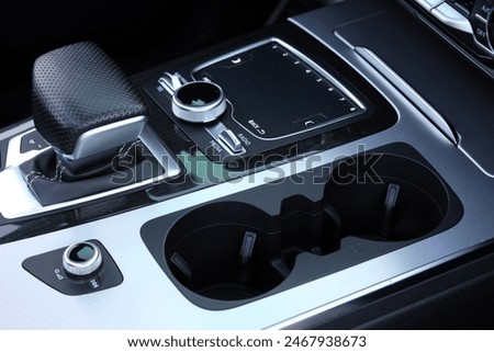 Close up cup holders and Selector automatic transmission. Cup holders inside modern car interior. Car inside.