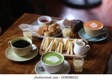 Close up a cup of Matcha green tea Latte art hot drink on wooden table background - Powered by Shutterstock