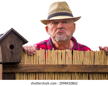 Close Up Of A Curious Man Standing Behind A Garden Fence