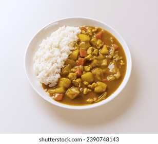 Close up of curry rice with curry, boiled rice, potato, carrot, onion and pork sirloin on dish and white floor, South Korea
 - Powered by Shutterstock