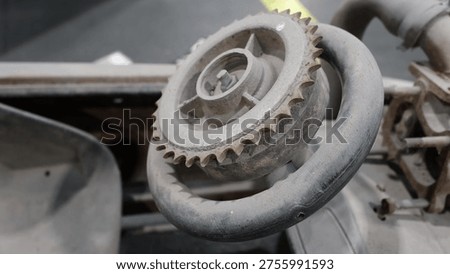 Close up of a custom steering wheel made from a metal gear sprocket on a DIY racing kart