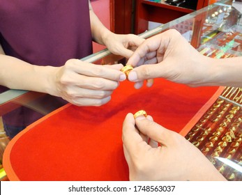 Close up of customer is checking ring before sell or buy at gold/pawn shop.