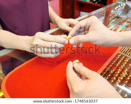 Close up of customer is checking ring before sell or buy at gold/pawn shop.