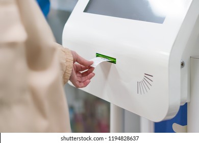 Close Up Customer Hand Pull A Ticket Number From Dispenser Machine To Wait In Queue In Post Office