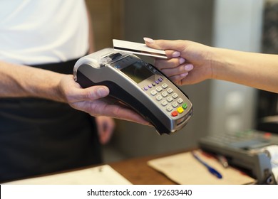 Close Up Of Customer Paying By Credit Card 