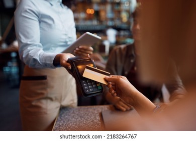 Close Up Of Customer Paying With Credit Card In A Restaurant.