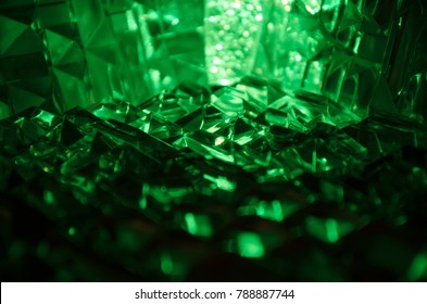 Close Up Of Cut Crystal In Mysterious Emerald Light.Magic Shiny Background.Abstract. 