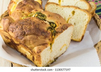 Close Up Of Cut Jalapeno Cheese Bread On A Plate.