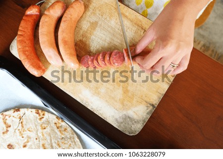 Close up Cut Sausage for  Homemade Pizza on wood table with Natural light.
