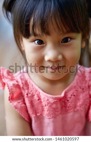 Close up of Cute Asian little girl is smiling happily.