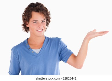 Close up of a cute guy showing copyspace in a studio