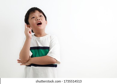 Close up cute little Asian boy having a good idea, finger pointing up, looking up, mouth open isolated on white background