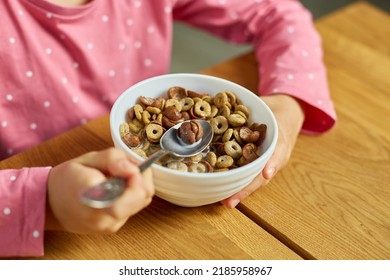 Close Up Cute Little Girl Enjoy Eating Cereal With Milk For Morning Breakfast With Appetite, How Tasty Healthy Food, Slow Motion Of Beautiful Child Having Breakfast At Home.