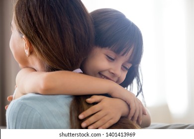 Close Up Of Cute Little Girl Hug Young Mom Or Nanny Showing Love And Care, Happy Preschooler Child Embrace Mother Thank Or Ask Forgiveness, Smiling Parent And Small Daughter Kid Cuddle Reconcile