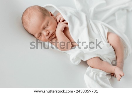 Close up of cute newborn baby sleeping on white background covered.Care,love,happiness concept