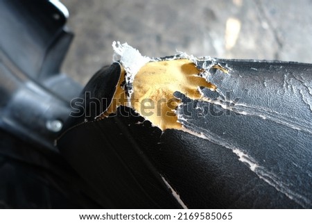 Close up of a damaged motorcycle seat or seat.