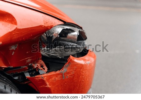 Close Up of Damaged Red Car Front End After Accident