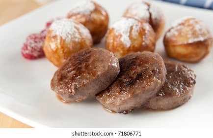 Close Up Of  Danish Breakfast With Sausage Patties And Round Pancakes