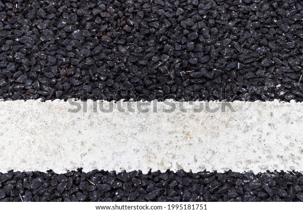 close\
up of a dark asphalt road divided by white paint, close up of white\
traffic lines on the dark asphalt road\
background