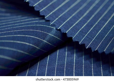 close up dark blue fabric of suit, photo shoot by depth of field for object
