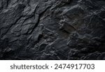 A close up of a dark gray rock formation with a rough texture.