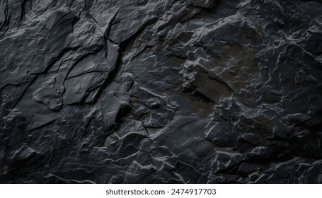 A close up of a dark gray rock formation with a rough texture. - Powered by Shutterstock