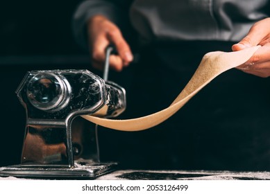 Close up dark photo of the pasta making machine in process. - Powered by Shutterstock