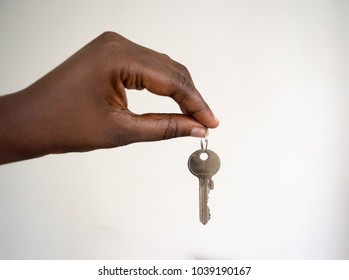 close up Dark skin African American female woman Hand giving keys on white background