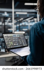 Close up of data center admin using laptop to setup machine learning systems handling information. IT specialist using notebook device to train neural networks to improve server farm operations