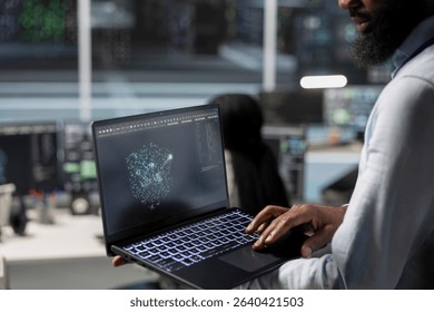 Close up of data center engineer using laptop to implement AI virtualization frameworks, improving resource allocation. Server hub worker does artificial intelligence predictive analysis on notebook