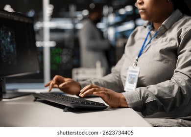 Close up of data center programmer coding, writing script on PC identifying bottlenecks. Server farm IT specialist typing on compute keyboard, troubleshooting computer bugs, implementing optimizations