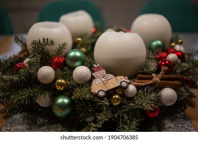 Close up of decorated Christmas pine tree advent wreath with white candles.