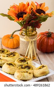 Close Up Of Decorated Table And Plate With Fresh Baked Beef Pumpkin Pinwheels.