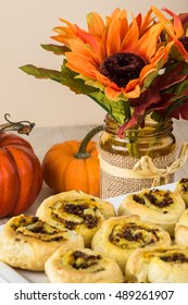 Close Up Of Decorated Table And Plate With Fresh Baked Beef Pumpkin Pinwheels.