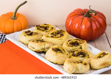 Close Up Of Decorated Table And Plate With Fresh Baked Beef Pumpkin Pinwheels.