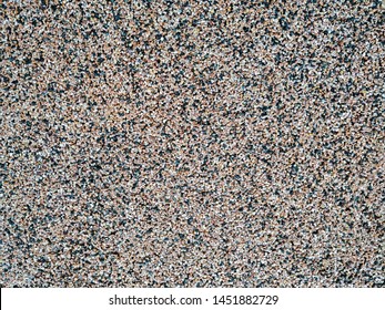 Close Up Of Decorative Quartz Sand Epoxy Coated Floor Or Wall Coating With Grey, Black And White Coloured Particles. Copy Space.