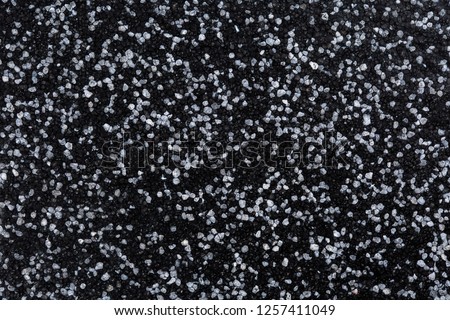 Close up of decorative quartz sand epoxy coated floor or wall coating with grey and black coloured particles