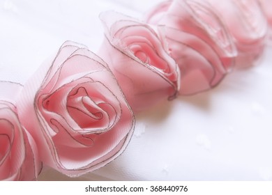 Close Up To Delicate Roses Of Fabric Sewn In A White Dress For A Party, A First Communion, Sweet Sixteen Or Wedding. 