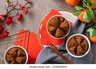 Close up of delicious fresh Chinese steamed sponge cake named Fa Gao for lunar new year festival traditional food over gray table background.