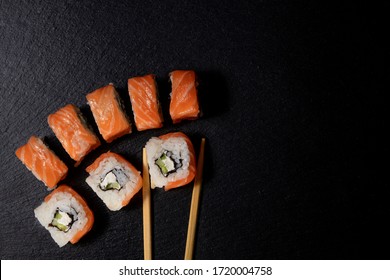 Close up delicious Japanese food sushi over dark background with copy space.