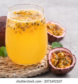 Close up of delicious juicy fresh passion fruit with sparkling juice on gray table background. - Powered by Shutterstock