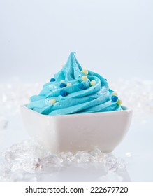 Close Up Delicious Light Blue Frozen Yogurt On White Bowl With Ice Pieces On Sides. Isolated On White Background.