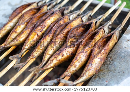 Close up of delicious, marinated grilled mackrele on the BBQ grill, seafood concept Stock photo © 