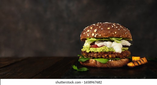 Close up of delicious vegan lentils burger on dark rustic background - Powered by Shutterstock