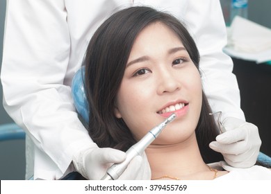 Close Up Dentist Curing A Asian Women Patient, Close Up Of Asian Women Having His Teeth Examined By A Dentist