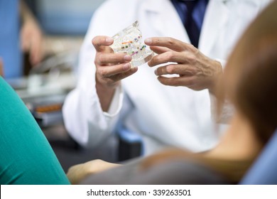 
Close Up Of Dentist Holding Model Of Teeth With Colorful Braces
