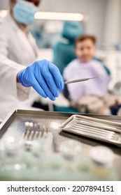 Close Up Of Dentist Using Dental Scraper Tool During Appointment With A Child. 