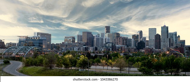 Close up of the Denver skyline with wispy clouds over the city